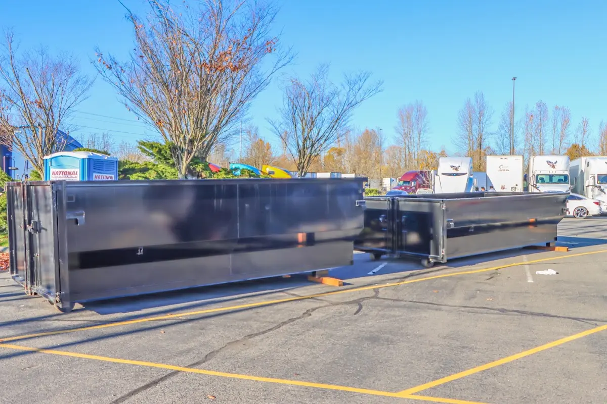 Professional dumpster rental service with roll-off container on residential driveway in Port Chester